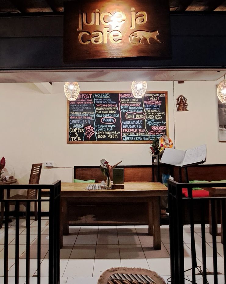 Inside Juice Ja Café in the evening, with the hand-written chalkboard menu